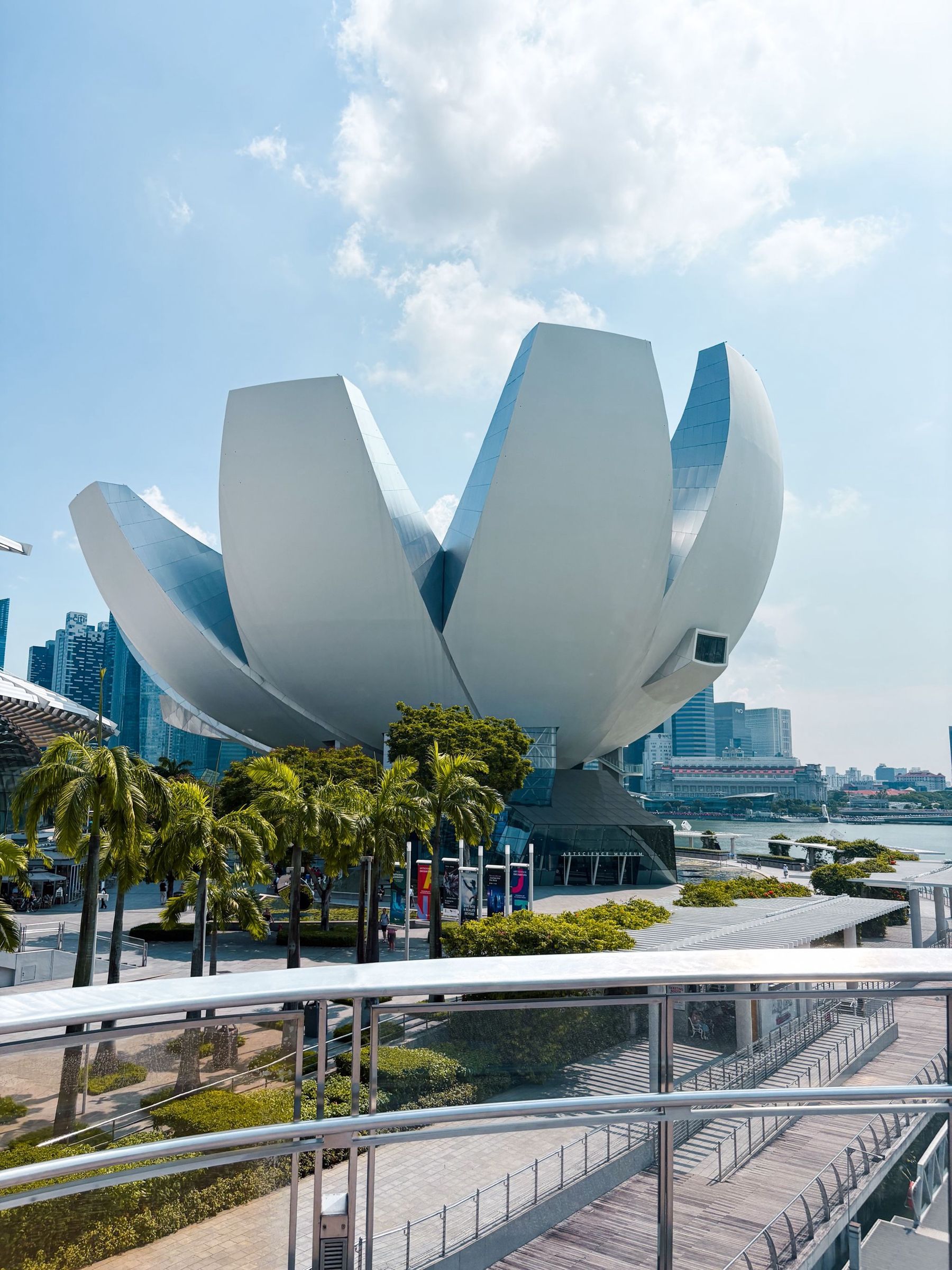 The ArtScience Museum under a bright sky with palm trees